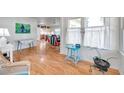 Bright living room featuring wood floors, white walls, lots of natural light, and vintage coastal décor at 2539 44Th S St, St Petersburg, FL 33711