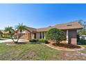 Beautiful home boasting lush landscaping, mature trees, and a well-manicured lawn at 3111 Bishop Dr, Safety Harbor, FL 34695