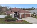 Charming single Gathering home boasts a well-manicured lawn, mature landscaping and a two-car garage at 3613 Pendleton Way, Land O Lakes, FL 34639