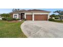 Well-maintained home featuring a two-car garage and manicured landscaping at 3613 Pendleton Way, Land O Lakes, FL 34639