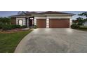 Traditional home with a two-car garage and a spacious driveway at 3613 Pendleton Way, Land O Lakes, FL 34639