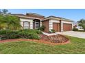 Charming home with a brick-lined garden and a well-maintained lawn at 3613 Pendleton Way, Land O Lakes, FL 34639