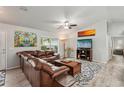 Cozy living room featuring a comfortable leather sectional, modern decor, and wood-look flooring at 3655 Candia Ave, North Port, FL 34286