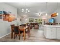 Open-concept living room flowing into the dining area and featuring stylish decor and ample space at 3655 Candia Ave, North Port, FL 34286