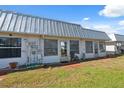Back of home featuring multiple sliding glass doors to access backyard at 4222 Richmere Dr # 4222, New Port Richey, FL 34652
