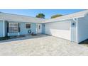 A one story home featuring a wide paved driveway and a one car garage at 4662 Dewey Dr, New Port Richey, FL 34652