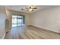 Bright living area with wood laminate floors and sliding glass doors to outdoor space at 518 Glenn Cross Dr, Ruskin, FL 33570