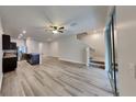 Spacious living area featuring wood laminate flooring, neutral walls, and adjoining kitchen at 518 Glenn Cross Dr, Ruskin, FL 33570