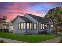 Charming home with manicured lawn and well-lit windows creates a warm inviting atmosphere at 600 26Th S Ave, St Petersburg, FL 33705