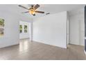 Bright living room offers new floors, fresh paint, lots of windows, and a ceiling fan at 600 26Th S Ave, St Petersburg, FL 33705