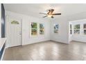 Bright living room boasts fresh paint, new floors, lots of windows, and a ceiling fan at 600 26Th S Ave, St Petersburg, FL 33705