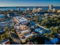 Aerial view of a townhome community with city skyline and waterfront views in the background at 642 Blue Taverna Ln, Clearwater, FL 33756