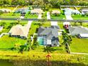 Expansive backyard with screened pool situated on a waterfront property with lush landscaping at 6725 Clair Shore Dr, Apollo Beach, FL 33572