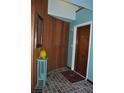 Unique foyer featuring wood wall, turquoise paint, and brick floor at 7219 Williams S Dr, St Petersburg, FL 33705