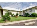 Condo exterior with lush green lawn and mature landscaping at 7310 Sunshine Skyway S Ln # 219, St Petersburg, FL 33711