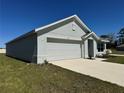 Well-maintained, single-story home shows simple landscaping and an attached two car garage at 11517 Timber Grove Ln, Brooksville, FL 34613
