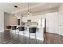 Modern kitchen features an island with seating, white cabinets, and pendant lighting, perfect for entertaining at 1227 E Madison St # 1004, Tampa, FL 33602