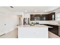 Modern kitchen featuring stainless steel appliances, a center island, and plenty of storage space at 12823 Wanderlust Pl, Parrish, FL 34219