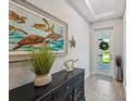 Bright entryway featuring a turtle-themed art and stylish decor at 1848 Sunset Preserve Way, Port Charlotte, FL 33953
