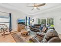 Comfortable living room with a ceiling fan, large window and leather furniture at 1848 Sunset Preserve Way, Port Charlotte, FL 33953