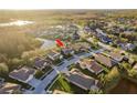 An aerial view of a house nestled in a lovely neighborhood with ponds and mature trees at 19122 Sunset Bay Dr, Land O Lakes, FL 34638