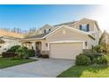 Two-story home with two-car garage, stone accents, and well-manicured lawn at 19122 Sunset Bay Dr, Land O Lakes, FL 34638