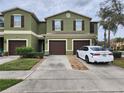 Townhome showcasing its exterior with a well manicured lawn and neutral color scheme at 2807 Lantern Hill Ave, Brandon, FL 33511
