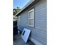 Side view showing home's blue siding and white trim, along with window details at 2980 64Th N Ave, St Petersburg, FL 33702