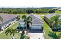 An aerial view of this charming home in a well-kept community, surrounded by mature trees and landscaping at 328 Siena Vista Pl, Sun City Center, FL 33573