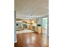 Bright kitchen featuring wooden cabinets, stainless steel appliances, and hardwood flooring at 3453 Garfield Dr, Holiday, FL 34691