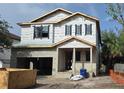 Two-story home featuring a concrete block exterior under construction with visible window frames and a covered entry at 3618 W Royal Palm Cir, Tampa, FL 33629
