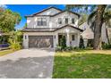 Charming two-story home with a well-manicured lawn, a driveway, and a garage at 3618 W Royal Palm Cir, Tampa, FL 33629