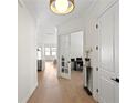 Bright hallway showcasing hardwood floors and white trim, leading to rooms filled with natural light at 3618 W Royal Palm Cir, Tampa, FL 33629