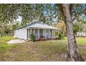 Quaint single-story home with a welcoming covered porch and a well-maintained front yard at 3814 N 48Th St, Tampa, FL 33605