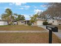 Inviting single-Gathering home with a screened porch, well-maintained lawn, and a neatly paved driveway at 5317 Tammy Ln, Holiday, FL 34690