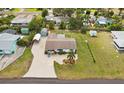 Aerial view of a home with well-maintained landscaping, shed, and a spacious driveway at 829 E 4Th St, Englewood, FL 34223
