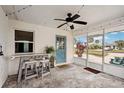 Cozy screened porch features bar seating and a ceiling fan perfect for relaxing or entertaining guests at 829 E 4Th St, Englewood, FL 34223