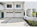 Close-up of townhomes with attached garages and well-maintained landscaping at 9770 Indian Key Trl # 102, Seminole, FL 33776