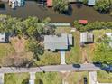 Aerial view of the property showcasing its private dock, waterside setting and proximity to surrounding neighborhood at 106 W North Branch Rd, Ruskin, FL 33570