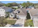Aerial shot showcasing the home's roofline, driveway, and surrounding neighborhood at 10604 Scenic Hollow Dr, Riverview, FL 33578