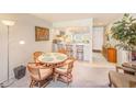 Cozy dining area seamlessly connects to the kitchen, featuring a breakfast bar and ample lighting at 13250 Ridge Rd # 10-4, Largo, FL 33778