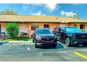 Exterior showcases a well-maintained townhome with parking spaces and landscaping for a welcoming appeal at 13250 Ridge Rd # 10-4, Largo, FL 33778
