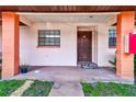 Charming front porch leads to the townhome's inviting entrance with a decorative front door at 13250 Ridge Rd # 10-4, Largo, FL 33778