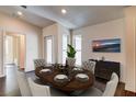 Well-lit dining room featuring wood-look floors, neutral walls, and a modern chandelier at 14334 Channel Dr, Largo, FL 33774