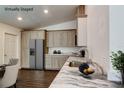 Bright kitchen featuring modern appliances, light wood cabinets, beautiful countertops and wood-look floors at 14334 Channel Dr, Largo, FL 33774