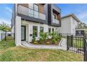 Contemporary two-story home featuring a landscaped front yard, a black wrought iron fence and a modern exterior at 1627 9Th N Ave, St Petersburg, FL 33713