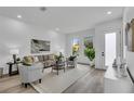 Bright living room with neutral tones, stylish furnishings, recessed lighting, and large windows at 1627 9Th N Ave, St Petersburg, FL 33713