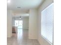 Bright living room featuring tile floors and large windows offering ample natural light at 17014 Oval Rum Dr, Wimauma, FL 33598