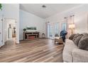 Cozy living room featuring modern flooring, comfortable seating, and a decorative fireplace at 18806 Autumn Lake Blvd, Hudson, FL 34667