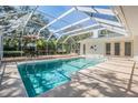 Enclosed pool area with ample seating, perfect for relaxation and entertainment at 18806 Autumn Lake Blvd, Hudson, FL 34667